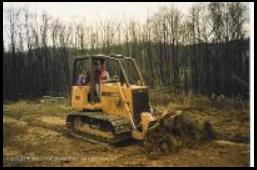 Ron works a Case 650 dozer on his property near Martinsville